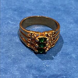 *Ornate Gold and Green Gemstone Ring with Intricate Design